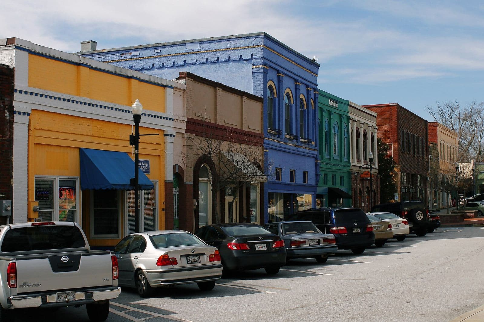 Colorful historic storefronts along a street in Olde Town Conyers