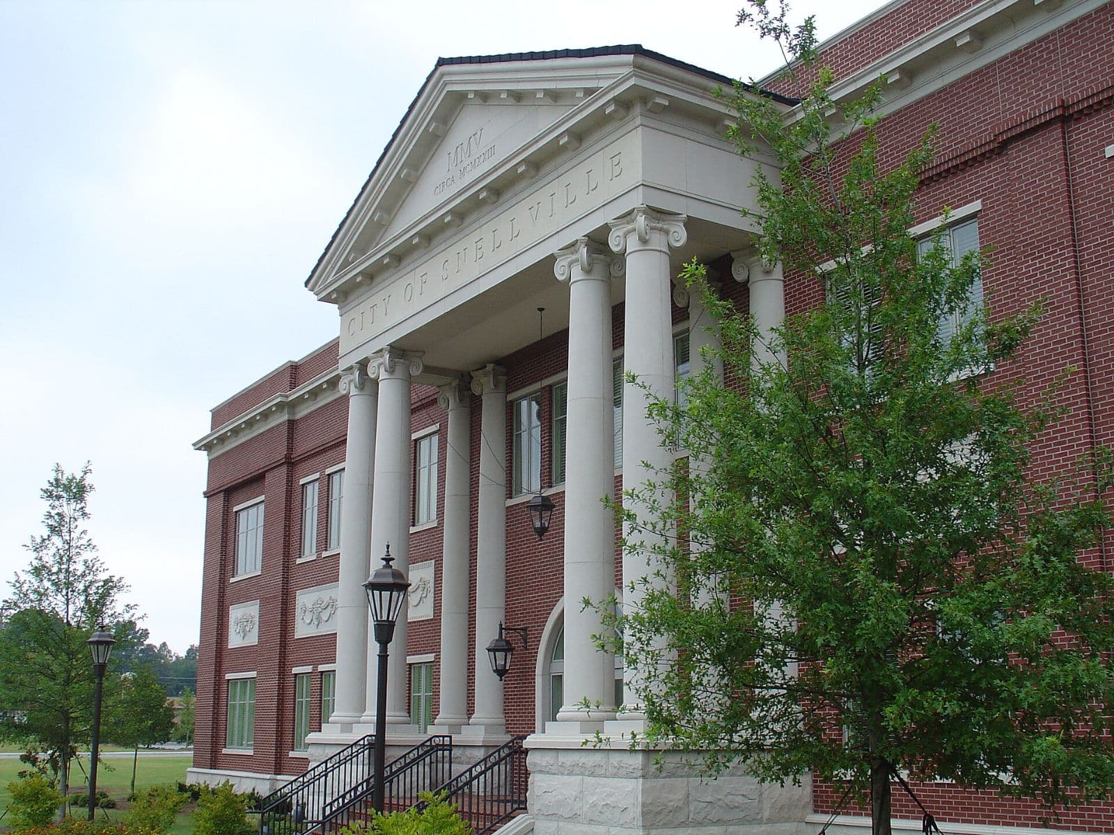 Columned brick Snellville City Hall building on a sunny day